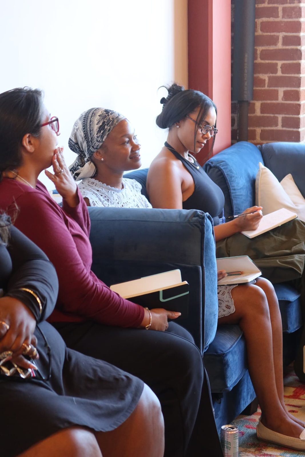 Participants listening, notebooks in hand
